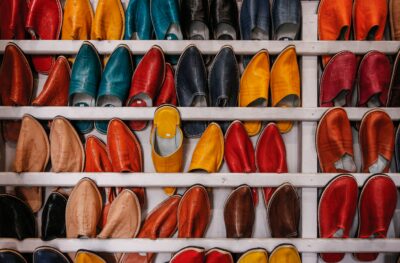 A shelf full of leather slippers in different colors