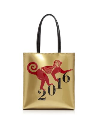 A gold handbag with a red monkey on it climbing up the numbers 2016