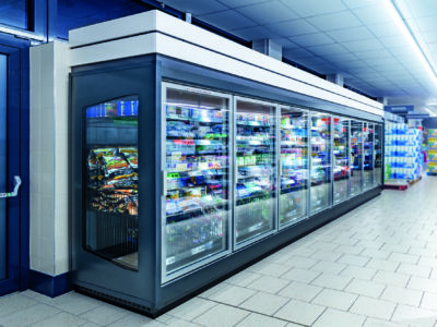 refrigerated shelves in a supermarket; copyright: HAUSER / Stefan Kuhn Photography
