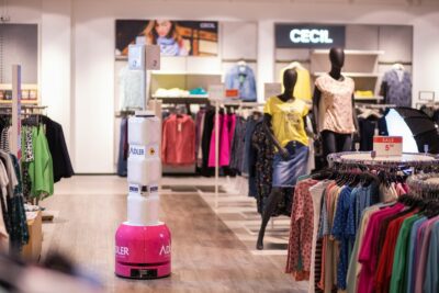 An inventory robot drives through a fashion store