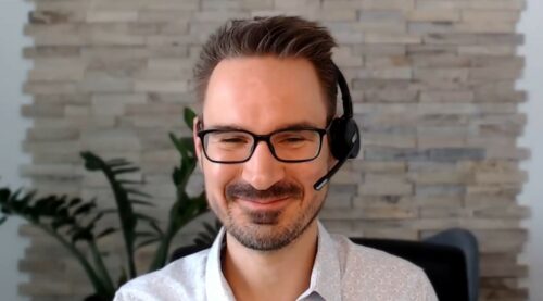 A man with headphones at a webtalk