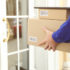 Image: Person holding packages in their hands standing in front of a door; Copyirght: PantherMedia/belchonock
