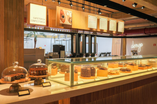 A counter with various cakes in a showcase