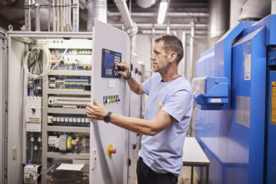 A Globus employee is at a power switch box.