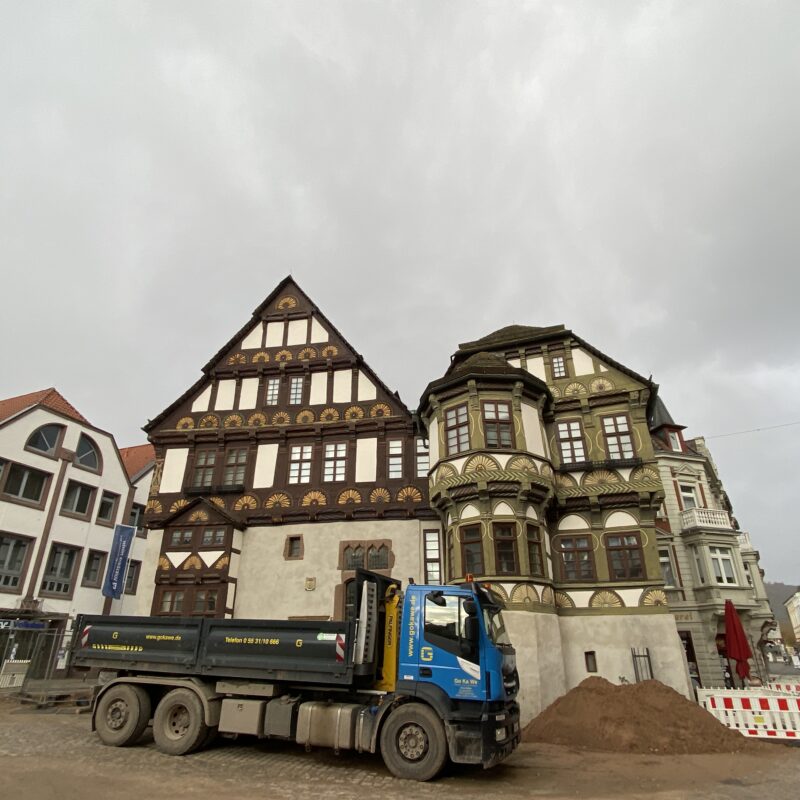 A construction site vehicle from a half-timbered house