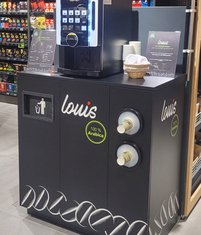 An automatic coffee maker with "louis" written on it