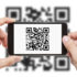 Person scanning a QR code on a white background with a smartphone; copyright: Bildagentur PantherMedia/Rangizzz