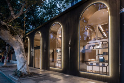 A modern style pastry store with curved arches and large windows