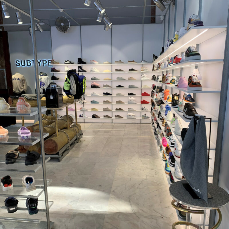 A shoe store with shoe racks on the walls