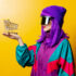 Woman with purple hair and colorful jacket and sunglasses holding small shopping cart; copyright: Masson-Simon