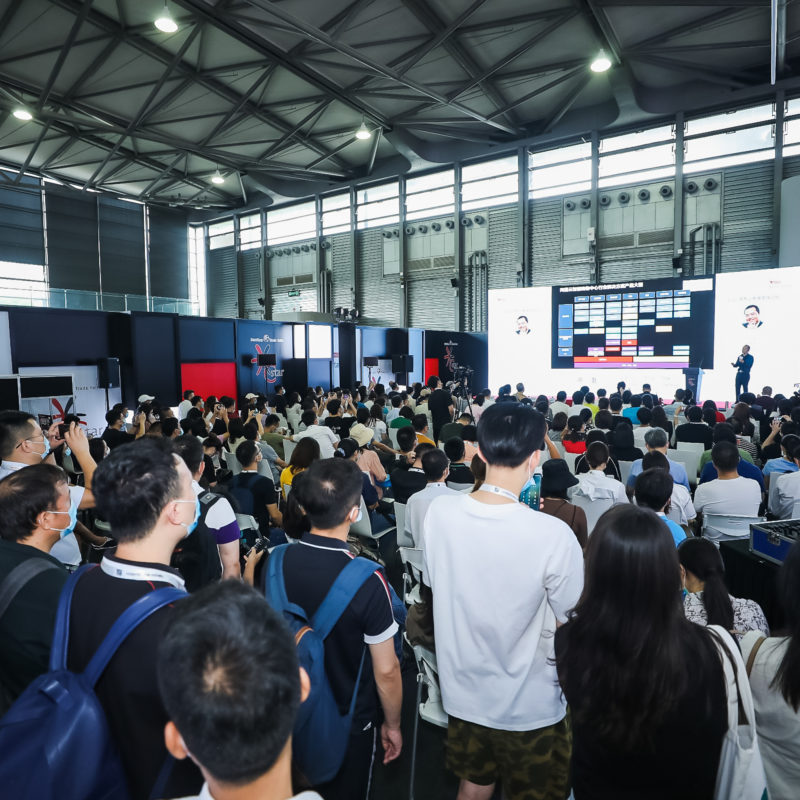 An exhibition hall full of visitors attending an event