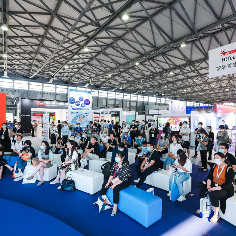 An exhibition hall full of visitors attending an event