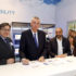 Three men signing a contract at EuroShop