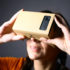 Woman holding a smartphone in a cardboard box in front of her eyes; copyright: PantherMedia/Mihai Barbu