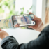 Woman takes a photo of a banknote with a smartphone; Copyright: Institut für industrielle Informationstechnik (inIT)