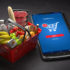 A red shopping basket filled with groceries and a smartphone beside it