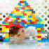Child looking through a LEGO building; copyright: panthermedia.net/romrodinka