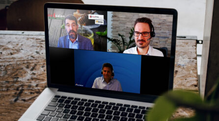 Three men having a webtalk on a laptop screen