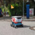Der fahrenden REWE "Lieferbot" fährt über eine Straße; Copyright: REWE Group