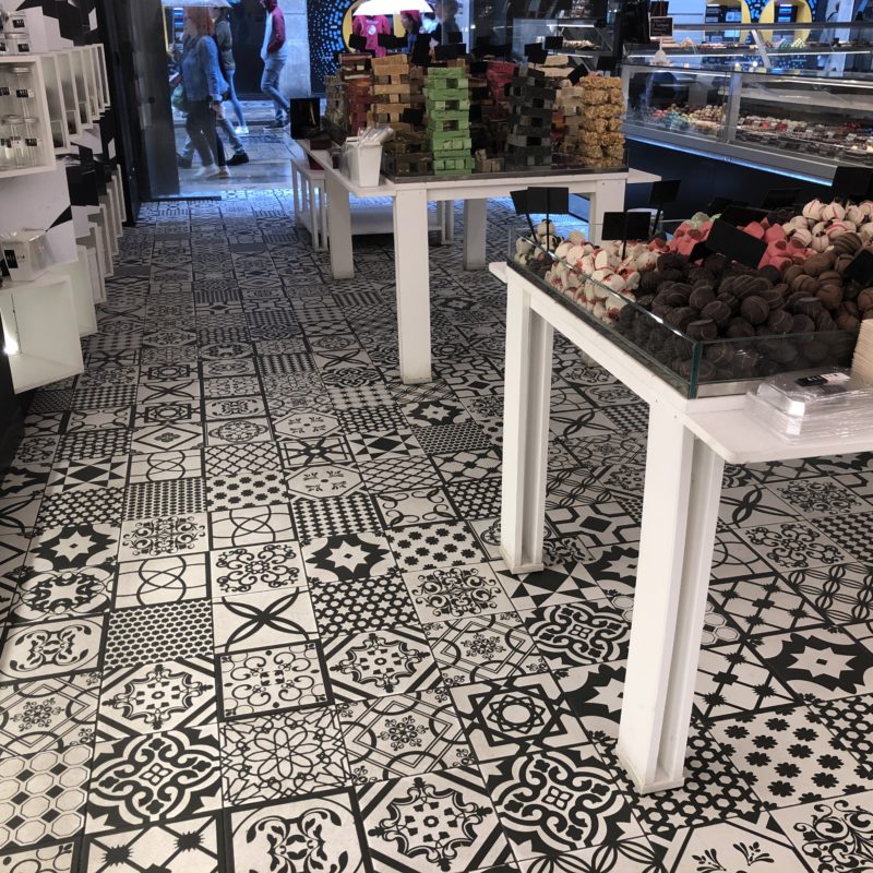 A tiled floor with black and white patterns in a shop