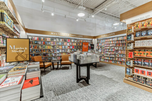 a branch of the bookseller Barnes & Noble with bookshelves and book tables