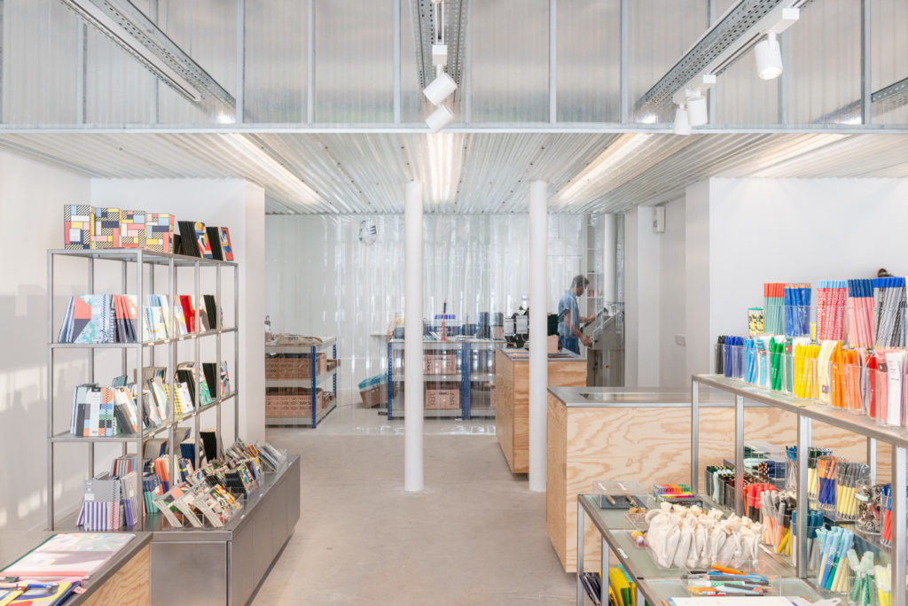 View into a modern stationery store with shelves and goods; copyright: Papier Tigre_Cent15 architecture_Caudroy photography