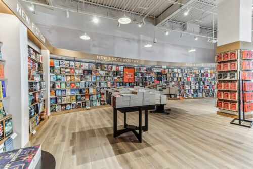 a branch of the bookseller Barnes & Noble with bookshelves and book tables